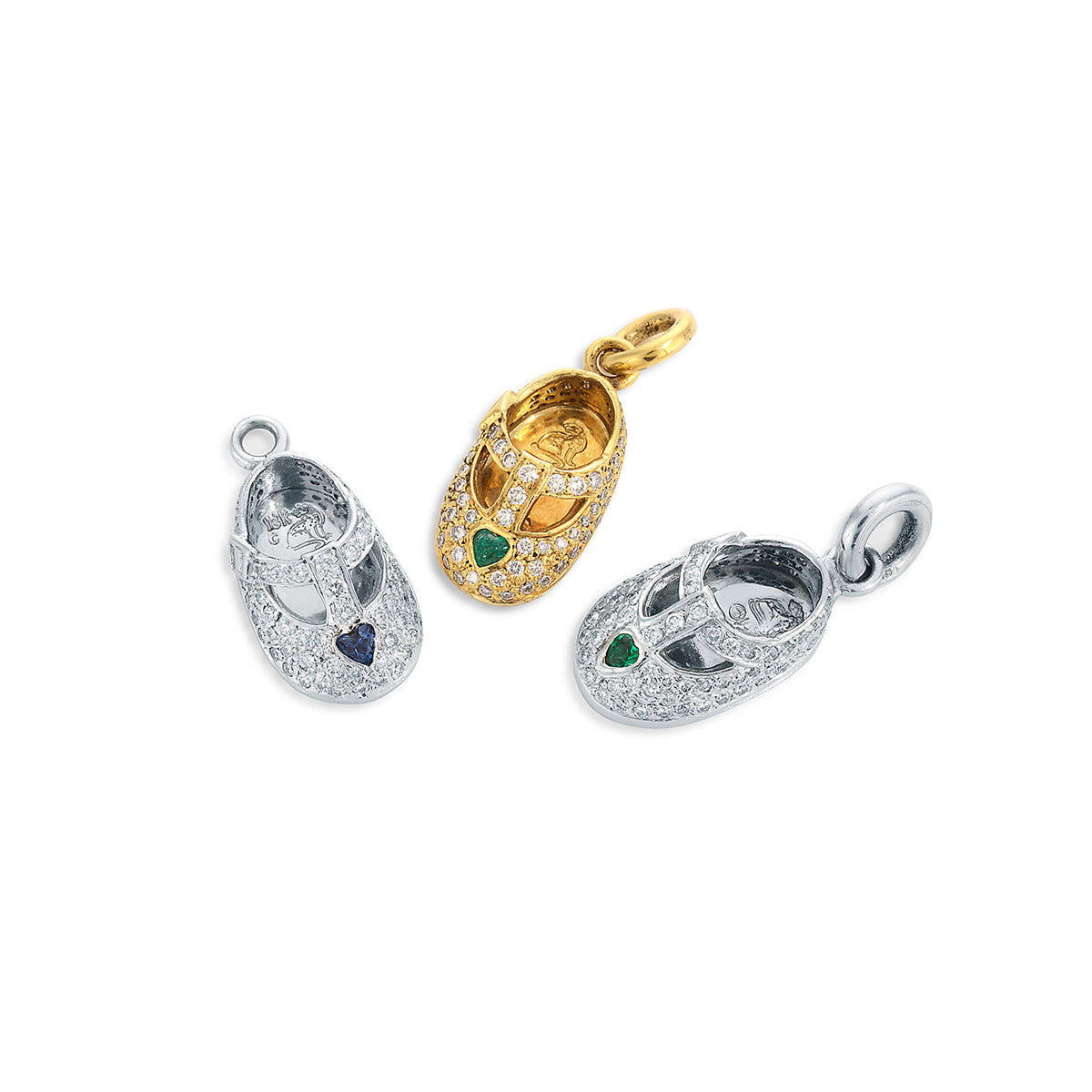 Baby shoe charms featuring heart shaped emerald and sapphires by Chicago's historic family jeweler, Lester Lampert.