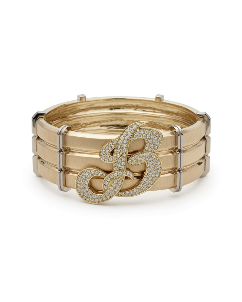 Gold bangle with a diamond-set script letter B
