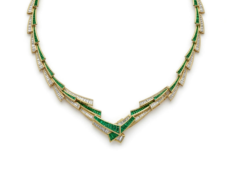 Gold necklace of overlapping emerald and baguette diamond segments