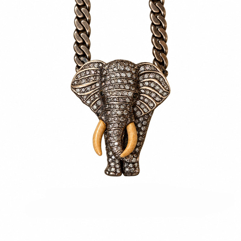 Elephant pendant set with diamonds, with ivory-colored tusks, on a curb-link chain