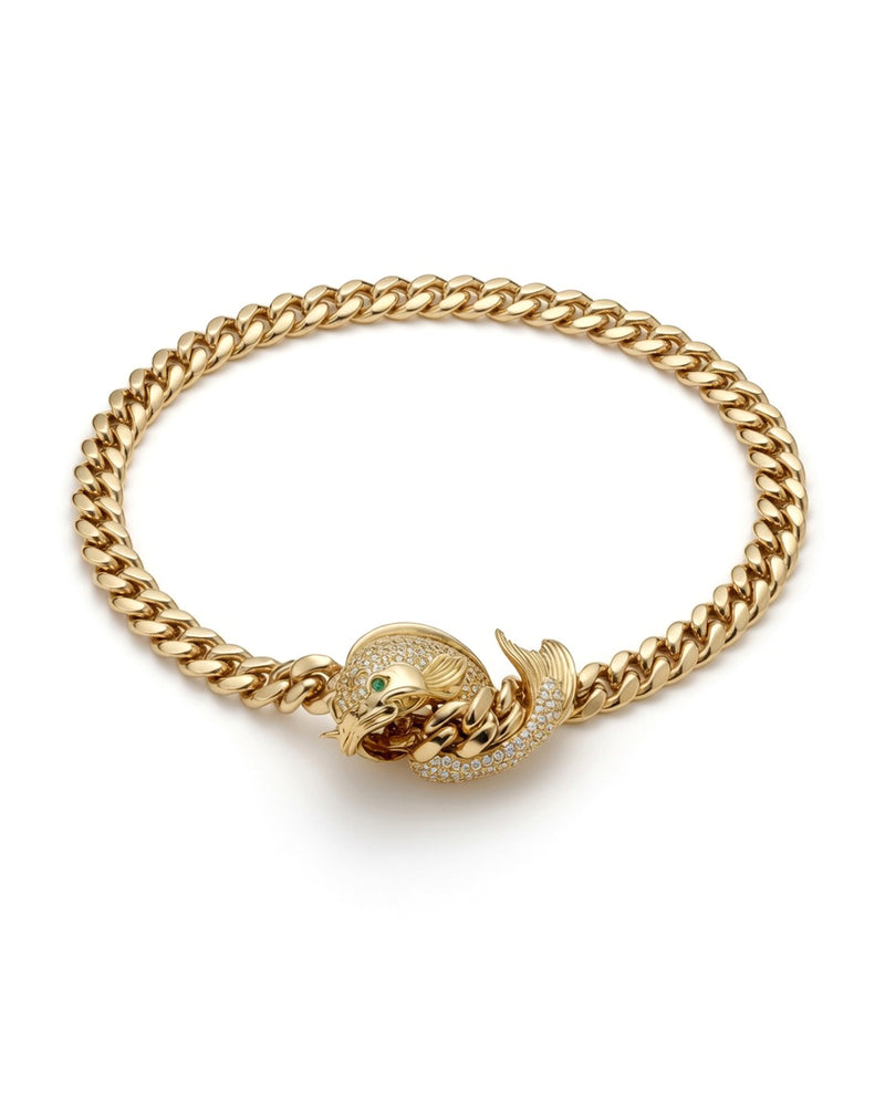 Gold curb-link necklace with a diamond-set fish clasp and a green stone eye