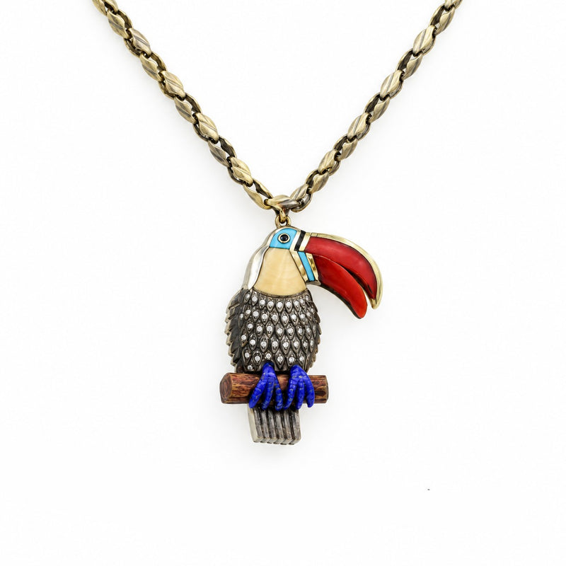 Toucan pendant with a red beak and blue feet on a chain