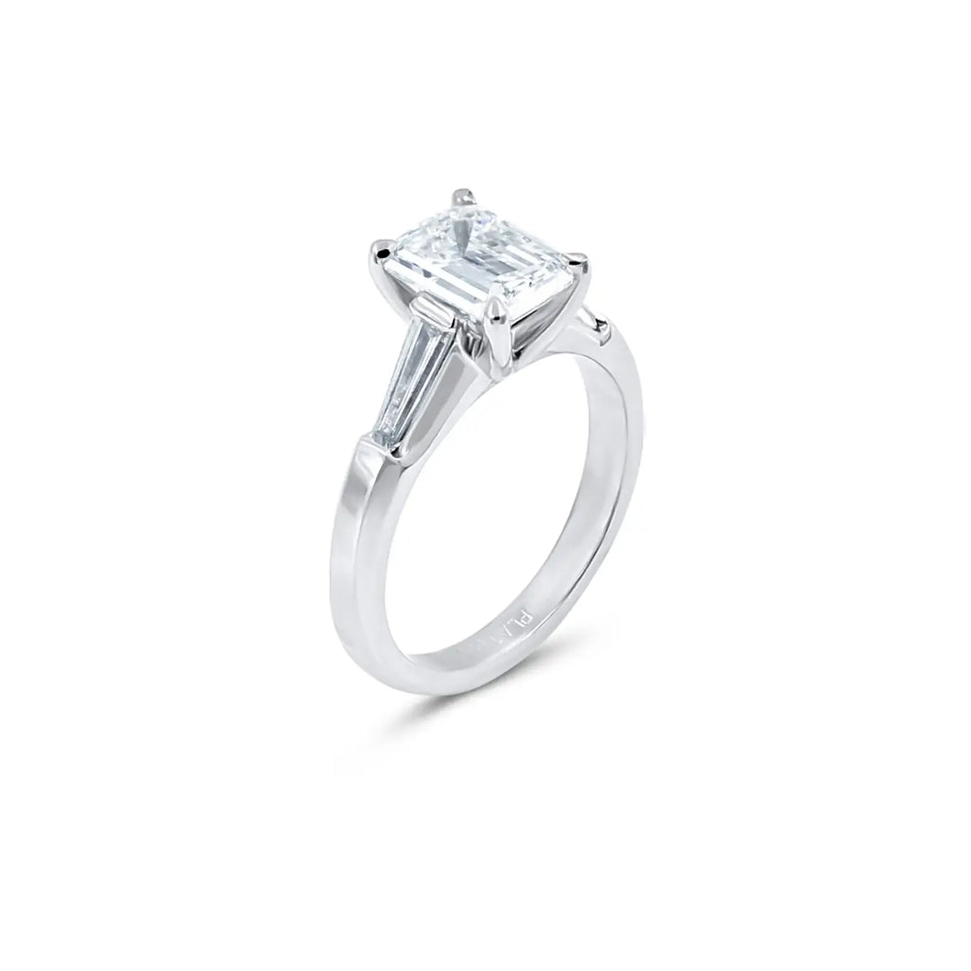 Lester Lampert Signature platinum engagement ring with emerald-cut diamond and tapered baguette sides, Chicago jeweler
