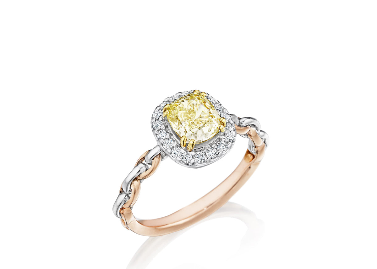 One of the world's most stunning engagement rings by Chigago jeweler Lester Lampert featuring a beautiful yellow diamond, surounded by brilliant white diamonds and a chain link style band.