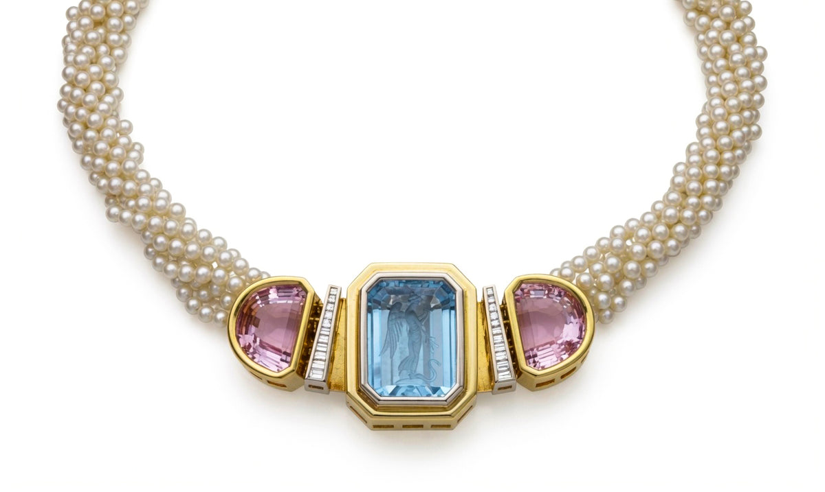 Seed pearl torsade with a carved blue center stone, two pink stones and baguette diamonds