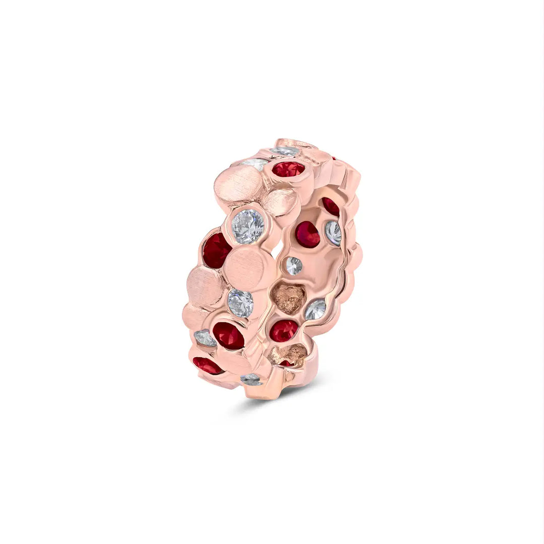 The BubbeLLes™ Ring by Lester Lampert in 18k rose gold, featuring Ideal-cut diamonds and striking rubies in a multidimensional design, crafted by a Chicago jeweler.