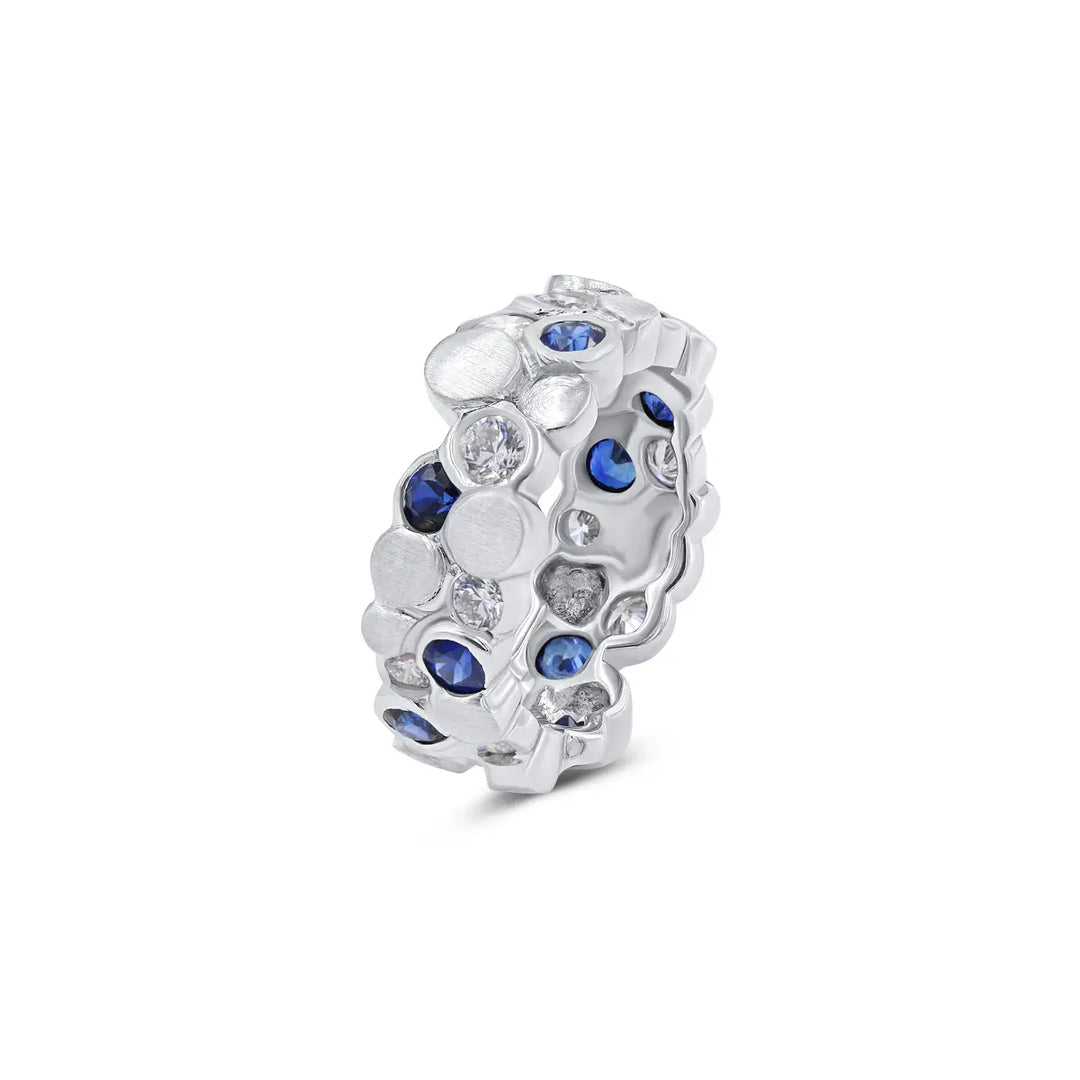 The BubbeLLes™ Ring by Lester Lampert in 18k white gold, showcasing Ideal-cut diamonds and deep blue sapphires arranged in a layered design, available at a Chicago jewelry store.