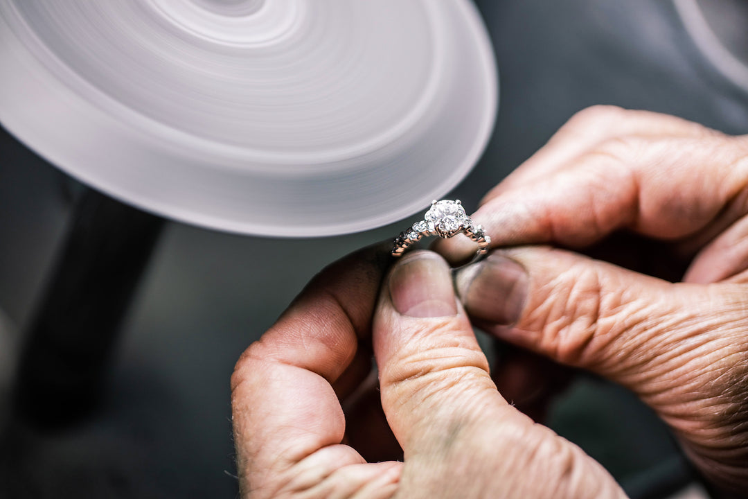 Chicago jeweler hand-polishing a diamond engagement ring, showcasing meticulous craftsmanship in the city's fine jewelry scene.