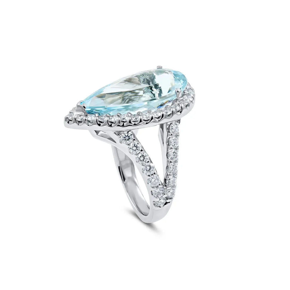 Custom aquamarine and diamond engagement ring in platinum, luminous blue center stone with sparkling accents